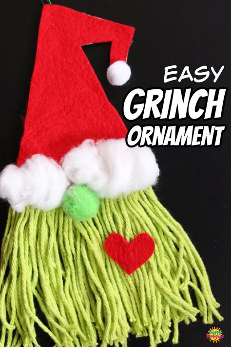 This adorable grinch gnome ornament is easy to make using a few basic craft supplies: Cardboard, Felt, Cotton Balls, Pom Moms, Yarn. Fun and easy Christmas craft for all ages. #HappyHooligans #Grinch #Craft #Ornament #Homemade #Gnome #Christmas #Kids #Art Grinch Hat Craft, Christmas Felt Crafts For Kids, Grinch Yarn Craft, Grinch Arts And Crafts For Kids, Grinch Christmas Ornaments Diy Kids, Grinch Ornament Craft, Grinch Projects For Kids, Whoville Crafts For Kids, Easy Grinch Craft