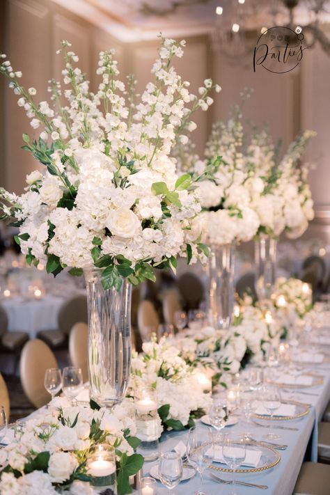 Classic Blue and White wedding, blue and white linens, head table with tall arrangements, floral table runners, clear gold chargers, ballroom wedding, blue linens, white floral, lush floral arrangements, luxury flowers, the Adolphus Hotel Dallas, #dallaswedding #dallasweddingplanner #weddingplanner #luxurywedding #theadolphus Winter Wedding High Centerpieces, Flower Arrangement Wedding Table, White Center Piece Wedding, Classic Wedding Flower Arrangements, Ballroom Wedding Inspiration, Classic Wedding Flowers Centerpieces, Ballroom Wedding Centerpieces, Tall White Floral Arrangements, White Wedding Flowers Centerpieces Tall