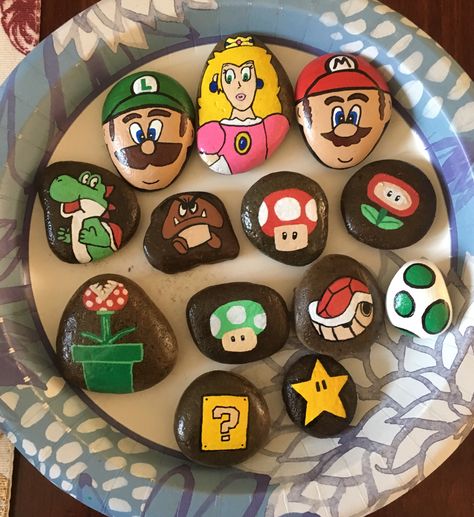 Mario Bros Rock Painting, Mario Rock Painting Ideas, Lego Painted Rocks, Mario Painted Rocks, Mario Rock Painting, Rock Painting Ideas Mario, Super Mario Painted Rocks, Mario Garden, Rock Painting Ideas Characters