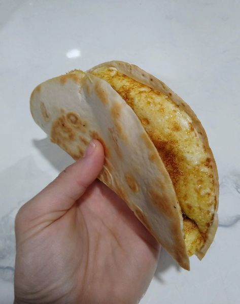 "Breakfast quesadilla. All you need is a tortilla, shredded cheese, and an egg or two. Scramble the egg in a bowl, add a handful of cheese. Pop the tortilla onto a medium-hot pan, wait a couple of minutes, pour the egg mix onto the tortilla, and let it sit until the egg begins to settle. Carefully fold the tortilla in half to make a perfect quesadilla." Easiest Breakfast, Egg Tortilla, Calorie Breakfast, Naan Flatbread, Bacon Fried Cabbage, Breakfast Quesadilla, Boxed Mac And Cheese, Satisfying Meals, Classic Grilled Cheese