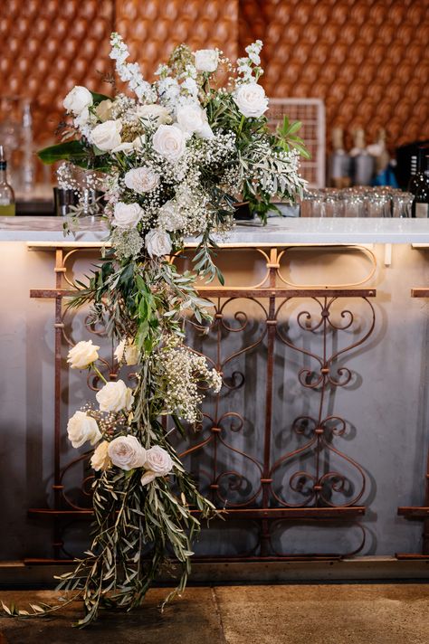 Cascading Floral Arrangements, Flowers Cascading Off Table, Floral Bar Arrangement, Wedding Bar Floral Arrangements, Cascading Sweetheart Table Arrangement, Cascading Bar Florals, Bar Flowers, Wedding Bar Floral Installation, Catering Table