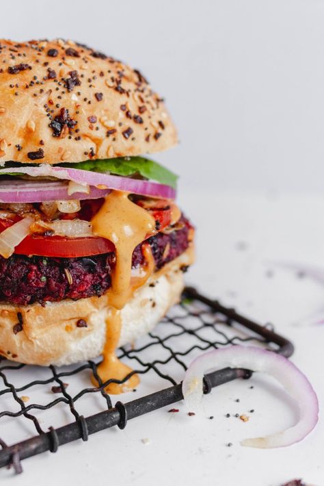 Vibrant black bean beet burger on a hamburger bun with lettuce, onion, tomato, and dripping with chipotle aioli sauce on a white backdrop. Beet Burger Recipe, Sweet Potato Pizza Crust, Beet Burger, Black Bean Burger, Healthy Snacks To Make, Veggie Burgers Recipe, Bean Burgers, Black Bean Burgers, How To Cook Mushrooms