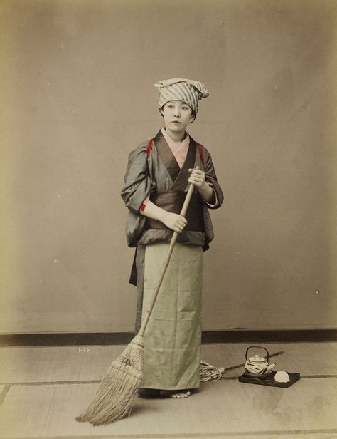 standing young woman wearing grey kimono, pale green apron and light blue and grey striped headscarf, holding a broom; tray with teapot and teacups and short-handled duster on floor at woman's left. Original from the Minneapolis Institute of Art. | free image by rawpixel.com Grey Kimono, Girl With Umbrella, Person Photo, Green Apron, A Broom, Japan Photo, Japan Girl, Blue And Grey, Japan Art