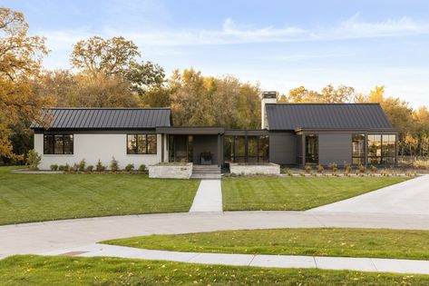 Photo 1 of 8 in A Grove of Century-Old Trees Lend an Ethereal Backdrop to a Modern Rambler in North Dakota - Dwell House With Black Roof, Modern Rambler, Rambler Remodel, Marvin Windows And Doors, Black Metal Roof, Black Roof, Corner Seating, Cedar Cladding, Prairie Style Houses