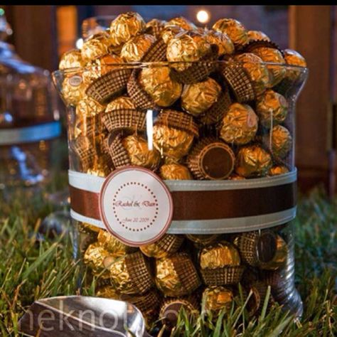 Guests scooped candies, like Ferrero Rocher and Jelly Bellies, from large,  decorative apothecary jars and took them home in white take-out boxes. Gold Candy Bar, Wedding Candy Table, Wedding Drink Bar, 50th Wedding Anniversary Party, Gold Candy, Candy Wedding Favors, 45th Birthday, Wedding Anniversary Party, Candy Table