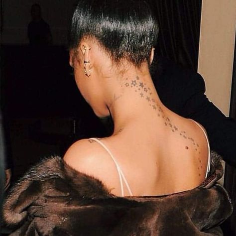 Our Favorite Star Tattoo Design Ideas (and What They Mean) - Saved Tattoo Rihanna Neck Tattoo, Rihanna Star Tattoo, Clouds And Stars Tattoo, Star Face Tattoo, Rihanna Tattoo, Tattoos Neck, Small Star Tattoos, Simple Tattoos For Women, Saved Tattoo