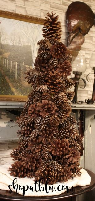 how to build a Giant pinecone tree from a tomato cage -The Blue Building Antiques Alabaster AL shopatblu Large Pinecones On Christmas Tree, Giant Pinecone Crafts Christmas, Growing A Pine Tree From A Pinecone, Grow Tree From Pinecone, Large Pine Cone Christmas Tree, Tomato Cage Crafts, Pine Cone Tree, Pine Cone Christmas Decorations, Tomato Cage Christmas Tree