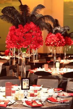 Elegant Feather and flower centerpiece for a black & red theme party Masquerade Party Centerpieces, Mascarade Party, Burlesque Party, Masquerade Party Decorations, Masquerade Prom, Masquerade Ball Party, Masquerade Theme, Masquerade Wedding, Prom Theme