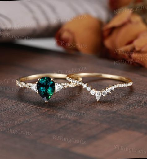 "MADE TO ORDER * Material: Solid gold(14K/18K white/yellow/rose gold) * DETAILS 57416/57458 Engagement Ring - Center stone: Teal sapphire 5*7mm pear cut - Side stone:Moissanite 0.29ct - Cut:Trillion/Round cut Wedding Band - Stones: Moissanite 0.18ct Shape: Pear cut 2*3mm * Click on the \"Pin It\" icon if you like this item * Custom Order We can make custom rings in almost any shape and style. If you want a specific model, please send us a clear picture and we will do our best.  * Shipping Most items take 3-4 weeks to create.I'm happy to rush your order, fees may apply, write me for details. * Payment Plans I offer payment plans. The minimum per payment will be $100. Write me your finger size, metal color, How much you would like to pay for the first payment. I will create a payment plan wh Green Wedding Rings, Green Engagement Rings, Antique Crown, Blue Green Sapphire Ring, Teal Sapphire Engagement Ring, Art Deco Rose, Sapphire Engagement Ring Set, Green Sapphire Engagement, Green Sapphire Engagement Ring