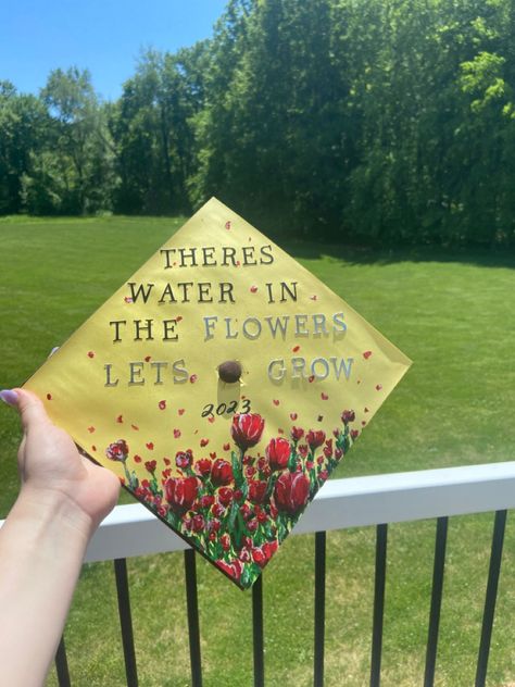 Hand holding a graduation cap that reads “There’s Water in the Flowers Let’s Grow” with a field of tulips painted on the bottom. Grad Cap Mac Miller, Mac Miller Cap Decoration Graduation, Grad Cap Ideas Mac Miller, Grad Cap Ideas Tyler The Creator, Mac Miller Senior Quotes, Mac Miller Grad Cap, Mac Miller Graduation Cap, Grad Cap Song Lyrics, Mac Miller Quotes