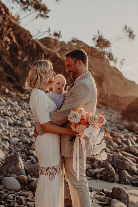 A romantic sunset beach elopement on Wategos Beach of a couple and their baby boy. | Photo by https://jasminsleemanphotographer.pic-time.com/ | Polka Dot Wedding Australian Beach Wedding, Romantic Sunset Beach, Engagement Pictures Beach, Byron Bay Beach, Casual Beach Wedding, Australian Beach, Beautiful Beach Wedding, Romantic Sunset, Pretty Wedding Dresses