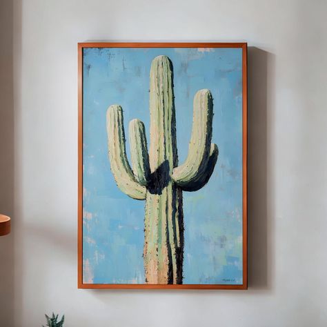 Add a touch of desert charm to your space with this beautiful oil painting-style print of a saguaro cactus set against a pale pink background. The delicate blue contrasts perfectly with the cactus green, creating a piece that's both striking and soft. Ideal for boho decor, this print is perfect for adding a bit of southwest style to your home, apartment, or dorm room. Whether you're decorating a girly dorm, seeking Mexican cactus art, or looking for a thoughtful housewarming gift, this piece bri Cactus Rose, Mexican Wall Art, Western Posters, Desert Decor, Beautiful Oil Paintings, Saguaro Cactus, Cactus Art, Cactus Print, Trendy Wall Art