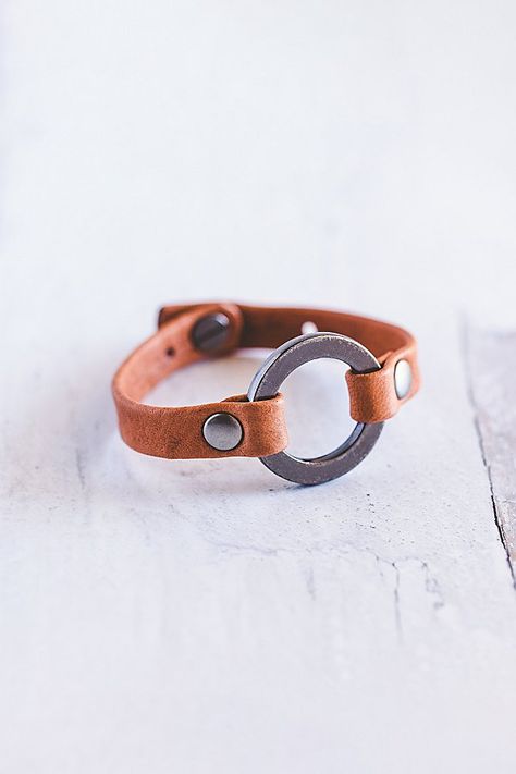 Designed to remind us that we all need to reconnect and ground to nature, our Grounding bracelet is handcrafted from the softest lamb leather and features a chunky antique silver ring with matching rivets. **Contents** * Lambskin leather, zinc alloy hardware * Button clasp closure * Handmade **Care/Import** * Made in the USA **Dimensions** * Adjustable to fit wrist sizes 6.5”-8” | Giving Bracelets Antique Silver Grounding Leather Bracelet at Free People in Orange Scrap Leather Projects, Leather Bracelet Diy, Boho Leather Jewelry, 2024 Creative, Leather Bracelet Tutorial, Leather Cord Jewelry, Handmade Leather Jewelry, Diy Leather Bracelet, Leather Accessories Handmade