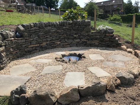 A lot of digging on a hillside to get a flat surface and a stone retaining wall. Hours of graft but happy with the result. Hillside Fire Pit Retaining Walls, Hillside Fire Pit, Dug Out, Stone Retaining Wall, Hillside Landscaping, Dry Stone, Retaining Walls, Retaining Wall, Flat Surface