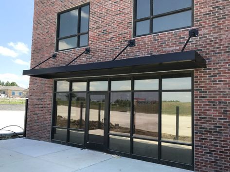 black metal awning Black Metal Awning, Metal Awnings For Windows, Awning Over Door, Metal Awnings, Door Overhang, House Awnings, Aluminum Awnings, Metal Awning, Townhouse Garden