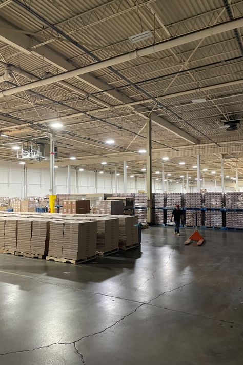 Photograph shows inside the 43,000 sq. ft. kit-packing facility full of skids of product. Fulfillment Center, Steel Buildings, The Hub, Building