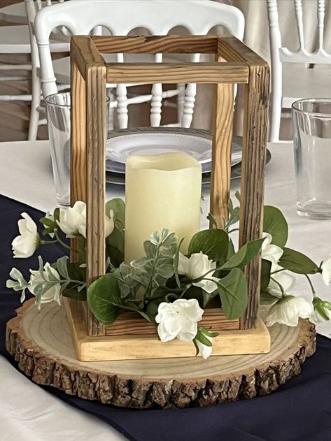 Just put together a new wooden lantern centerpiece with greens and flowers that would look fantastic adorning your wedding reception tables. 💕 #delawareweddingvenue #farmweddingde #wedding #centerpiece #candlecenterpiece #farmwedding #weddingreception Centerpieces Wedding Country, Rustic Wooden Centerpieces, Wedding Centerpieces Diy Lantern, How To Decorate Lanterns, Lantern Table Decor Wedding, Wedding Centerpieces With Fairy Lights, Wood Lantern Table Centerpieces, Wood Frame Centerpiece Wedding, Wooden Centerpieces Wedding