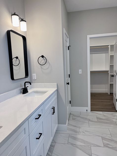 Grey And White Master Bath, Grey Bathroom With White Cabinets, Bathroom Flooring White Cabinets, Gray Marble Floor Bathroom, Black Grey White Bathroom Ideas, Bathroom Remodel White Cabinets, Bathroom White Marble Floor, White Vanity Grey Walls, Grey Wood Floors Bathroom