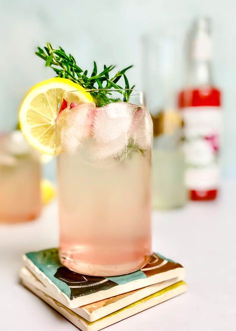 Rose lemonade is perfect for Memorial Day. Enjoy as a non-alcoholic beverage, or add a splash of vodka for a perfect light cocktail! ROSE LEMONADE RECIPE: https://sinfulkitchen.com/rose-water-lemonade/ How To Make Lemonade, Bbq Drinks, Cocktail Rose, Edible Rose Petals, Light Cocktails, Rose Lemonade, Edible Roses, Lemon Uses, How To Make Rose