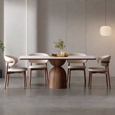 This is a simple style dining table. It is composed of rock plate table top, multi-layer solid wood bearing board and two semi-circular bases, with a sense of design, unique shape and dynamic. The table is supported by thick rock slab and multi-layer solid wood, which is resistant to wear and scratches and has strong load-bearing capacity. The base is made of ash wood solid wood, stable and tough, but also resistant to corrosion and moisture, bearing capacity is stronger, not easy to deformation Modern Contemporary Kitchen Table, Light Color Dining Table, Modern Dinner Chairs, Modern Dining Tables And Chairs, Wayfair Dining Room, Abstract Dining Table, Massive Dining Table, Dining Table 6 Seater Modern, 6 Seater Dining Table For Small Space