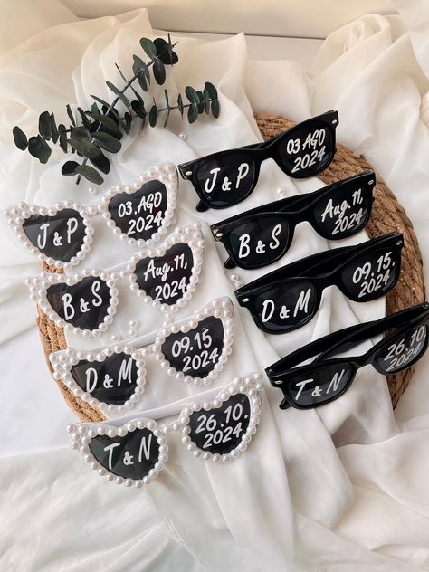 Welcome To Love Design Gift's! These special products we designed for you can be used for birthday, baptism ceremony, babyshower party, celebrations, newborn gifts, wedding gifts, engagement gifts, muslim gifts, openings etc. You can use it on all your special days. These heart shaped lightweight sunglasses are a perfect prop for your guests use in pictures taken at your wedding. As seen on TikTok, wedding sunglasses trend can be customized with your wedding date and initials of the Bride and Gr Favours For Wedding, Wedding First Aid Kit, Wedding Guest Favors Ideas Unique, Unique Wedding Gifts For Guests, Wedding Sun Glasses, Sunglasses Wedding Reception, Wedding Sunglasses Trend, Wedding Sunglasses For Guests, Wedding Extras Touches