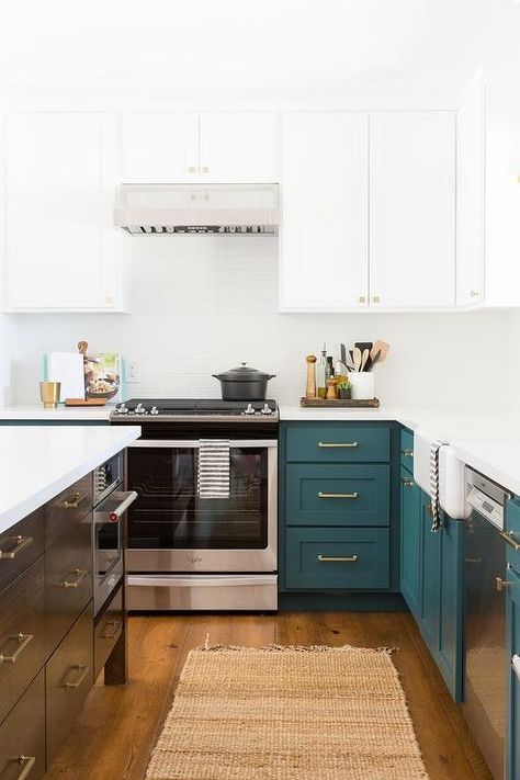 Peacock blue kitchen cabinets accented with brass pulls are topped with a white quartz countertop fixed against white backsplash tiles. Peacock Kitchen Cabinets, Peacock Blue Cabinets, Teal Backsplash Kitchen, Peacock Kitchen, Modern Grey Kitchen, Top Kitchen Trends, Grey Kitchen Designs, Blue Kitchen Cabinets, Backsplash Tiles