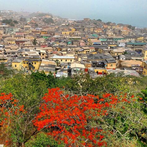 Cape Coast, Ghana  - the colorful #city of #capecoast as seen from the hilltop fort william.  the portuguese called the settlement 'cabo…” Ghana Landscape, Cape Coast Ghana, Cape Coast, Fort William, Ghana, Fort, Cape, Water, Travel