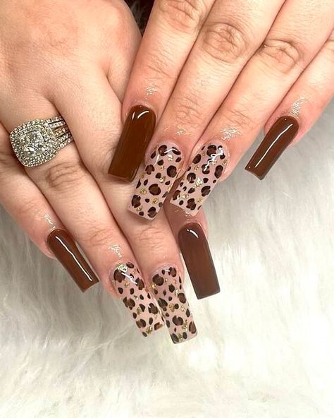 This nail design boasts rich chocolate brown hues contrasted with transparent sections that reveal detailed cheetah prints. It exudes a sense of luxury and refinement, ideal for individuals seeking to make a striking impression while maintaining an air of sophistication. The harmonious fusion of earthy shades and the animal motif creates a stylish and enduring allure. Cheetah Print Nail Designs, Nails Sophisticated, Chocolate Brown Nails, Essie Ballet Slippers, Cheetah Print Nails, 23 Summer, Nail Base Coat, Nude Polish, Essie Gel