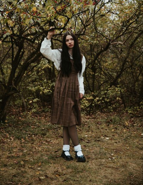 Wearing brown overall plaid dress over a white button up dress shirt with lacey socks and mary jane shoes. Surrounded by fall leaves Autumn Leaves Outfit, Plaid Dress Outfit Fall, Brown Overalls Outfits, Outfits With Socks, Plaid Dress Outfit, White Button Up Dress, Brown Overalls, Overalls Outfits, Dress With Flats