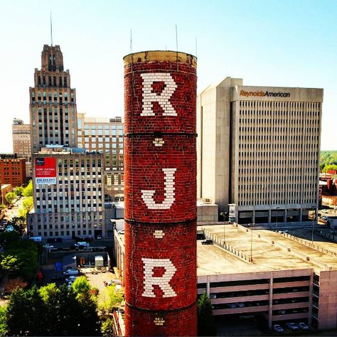 Aerial photo: RJR Smokestack Between New and Old Reynolds American Headquarters Buildings. Winston-Salem, NC. #WinstonSalem #WingsOverWinston Reynolda House, Piedmont Airlines, Winston Salem North Carolina, Winston Salem Nc, North Carolina Homes, Lounge Bar, Arts District, Winston Salem, Aerial Photo