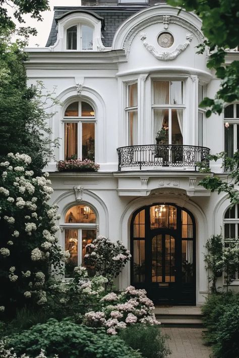 White stucco townhouse facade with swirling patterns subtle ridges and stone accents in London