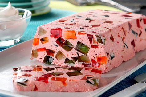 Orange, lime and strawberry gelatin cubes suspended in creamy pink gelatin is a dessert classic. When sliced, the gelatin cubes shimmer like jewels. Jello Mold Recipes, Strawberry Pretzel Dessert, Pretzel Desserts, Dessert Squares, Jello Dessert Recipes, Custard Desserts, Gelatin Dessert, Jello Desserts, Jello Recipes