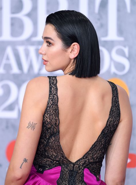 Dua Lipa Has Been Building Her Collection of Tiny Tattoos Since 2015 Tree Tattoo Finger, Dua Lipa Tattoo, Tattoos And Their Meanings, Thorn Tattoo, Palm Tree Tattoo, Fire Tattoo, Bad Tattoos, Unique Tattoo Designs, Bee Tattoo