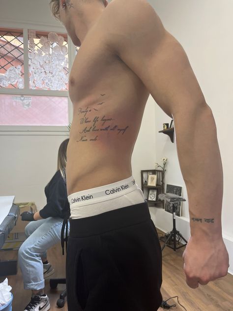 Rib Cage Tattoos For Men Quotes, Rib Writing Tattoo Men, Mens Side Tattoos Ribs, Rib Cage Tattoos For Men, Male Rib Tattoos, Side Tattoos For Men Ribs, Men’s Rib Tattoo, Men Rib Tattoo, Rib Tattoo Men