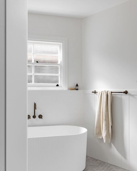 Photography + styling // luck Cottage - We went with a more classic cottage look in our main bathroom, this space gets all the natural… | Instagram Fluted Bath, Modern White Bathroom, Sandstone Wall, Serene Bathroom, Classic Cottage, Cottage Renovation, Coastal Bathrooms, Photography Styling, Main Bathroom