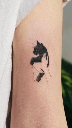 50 Rad Cat Tattoos To Immortalize Your Companion Three Legged Cat Tattoo, Black And White Cat Tattoo Ideas, Cat Tattoo On Arm, Black Kitten Tattoo, Cat Marking Tattoo, Black Cat Memorial Tattoo, Cat Tattoo Arm, Pet Cat Tattoo, Tattoo For Cat That Passed