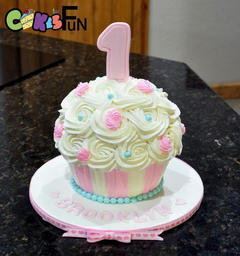 Giant cupcake for a first birthday. Buttercream frosting. I made the base of the cupcake with the Wilton cupcake pan and the top with a 1/2 6” ball pan. Giant Cupcake Recipes, Chocolate Giant Cupcake, Cupcake Smash Cake, Cupcake Smash Cakes, Girls First Birthday Cake, Giant Cupcake Cakes, Big Cupcake, Cupcake Tutorial, Smash Cake Girl