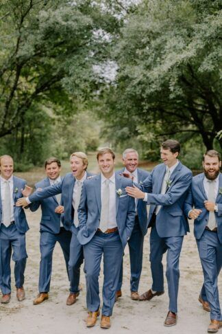 Dusty Blue Tux Groomsmen, Dusty Blue Wedding Suit Groomsmen, Dusty Blue Mens Suit Wedding, Mens Tuxedo Wedding Blue, Slate Blue And Gold Wedding, Slate Blue Tuxedo, Blue Tuxes Wedding, Mens Tux Colors For Wedding, Wedding Floral Arrangements Blue