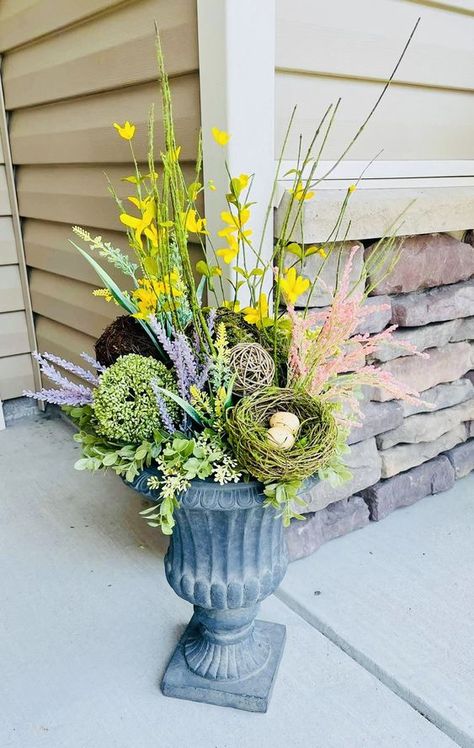 DIY Easter Decorations Which Are So Easy And Super Adorable - RecipeMagik Summer Urns Front Doors, Spring Outdoor Urns Front Doors, Fake Spring Planter Ideas, Spring Outdoor Flower Pots Front Porches, Easter Outdoor Planter Ideas, Spring Porch Pots Planters, Easter Planters Front Door, Spring Urn Planter Ideas, Easter Pots Outdoor