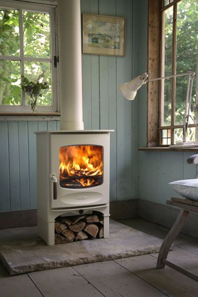 wood burning stove on stone pad | interior design + decorating ideas Solid Fuel Stove, Best Tiny House, Into The Wood, Log Burner, Stove Fireplace, Wood Burner, Cozy Fireplace, Into The Woods, Style At Home