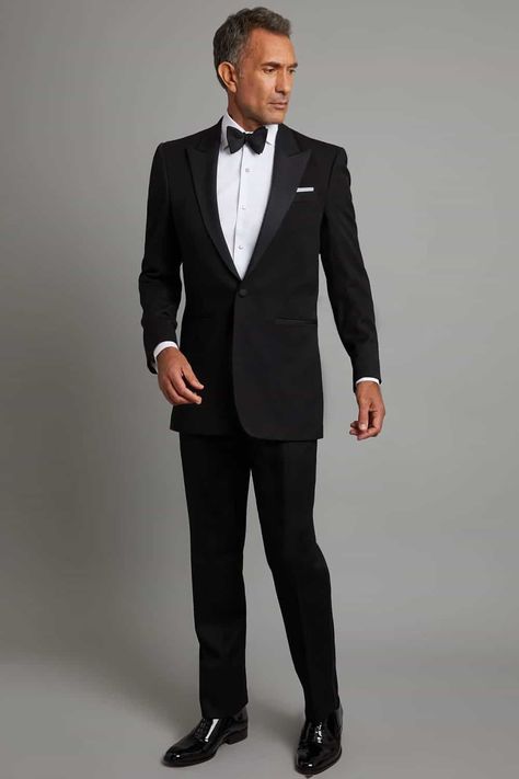 Man wearing black tie attire for a formal wedding. This outfit first appeared in the article: How A Man Should Dress For A Wedding: From Groom To Guest, on MensFlair.com Black Formal Wear Men, Men Black Tie Wedding Guest Attire, Black Tie Attire Men, Black Tie Mens Attire, All Black Formal Attire, Black Tie Optional Attire, Wedding Attire Guide, Black Tie Wedding Guest Attire, Black Tie Men