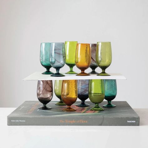 Hand- Blown Stemmed Drinking Glass, set of 6. On sale from $75, regularly $100 Introducing our Hand-Blown Stemmed Drinking Glass Set of 6, where elegance meets craftsmanship for a truly refined drinking experience. Elevate your gatherings and everyday moments with these exquisite glasses, each a testament to the artistry of hand-blown glass. Crafted by skilled artisans, each glass in this set is a unique masterpiece, showcasing the beauty of imperfection and individuality. The stem of th... Urban Outfitters Kitchen, Floral Candle Rings, Drinking Glass Sets, Metal Kitchen, Creative Co Op, Amber Color, Drinking Glass, Stemware, Glass Set