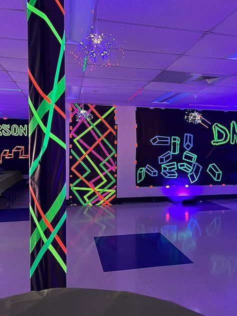 If you need neon party ideas, then you'll want to see this middle school dance decor! Throw a black and white party with glow in the dark tape, black school paper - it's an easy DIY party that glows in the dark! Lumo Party Decor, Neon Nights Homecoming, Pole Decorations Ideas Party, Elementary School Glow Dance, Glow In The Dark Ceiling Ideas, Neon Party Ideas Decoration Diy, Halloween Glow Party Ideas, Glow In The Dark Party Activities, Diy Dance Decorations