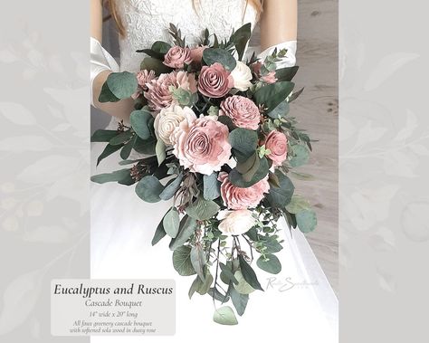 Eucalyptus and Ruscus Wedding Flowers | Dusty Rose Soft Sola Flower Bridal Cascade Bouquet Bridesmaid Groom Boutonniere Toss Florals Decor 🎕 About this collection: Inspired by eucalyptus, the handmade Eucalyptus and Ruscus collection is a soft mix of artificial spiral eucalyptus, seeded eucalyptus, silver dollar eucalyptus, and Italian ruscus, featuring specially softened sola flowers in shades of Dusty Rose. The comfortable handle is finished with jute, with some stems exposed for a natural lo Wedding Flowers Dusty Rose, Dusty Rose Wedding Bouquet Greenery, Dusty Rose And Eucalyptus Bouquet, Wedding Flowers Eucalyptus Pink, Ruscus Wedding, Dusty Rose Bridal Bouquet, Eucalyptus Pink Bridal Bouquet, Pink Roses And Eucalyptus Bouquet, Eucalyptus Bridal Bouquet