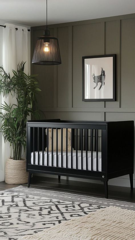 A modern green nursery with deep green walls, a black crib, minimalist decor, and a statement pendant light for a bold look. Modern Nursery Black Crib, Boy Nursery Ideas Black Crib, Green Walls Black Furniture, Moody Nursery Boy, Boy Nursery Black Crib, Black And Green Nursery, Baby Boy Green Nursery, Dark Green Nursery Boy, Black Crib Nursery Ideas