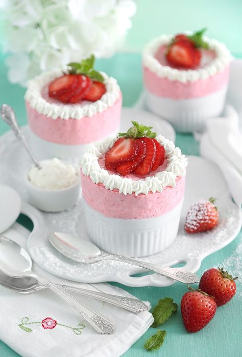 Tall pink chilled souffles garnished with sliced strawberries and whipped cream rest on a porcelain dish. Strawberry Souffle, Dinner Party Dessert, Dinner Party Desserts, Strawberry Whipped Cream, Souffle Recipes, Cake Mug, Strawberry Mousse, French Dessert, Strawberry Puree