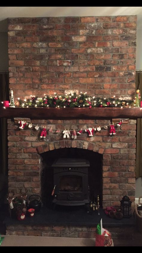 Christmas fireplace lights decoration garland red brick  Santa's washing line Christmas Fireplace Decorations Ideas, Simple Christmas Fireplace, Fireplace Mantle Decor Christmas, Fireplace Ideas Christmas, Christmas Brick Fireplace, Fireplace Decorations Christmas, Christmas Fireplace Mantle Decor, Christmas Fireplace Mantle Decorations, Christmas Fireplace Ideas