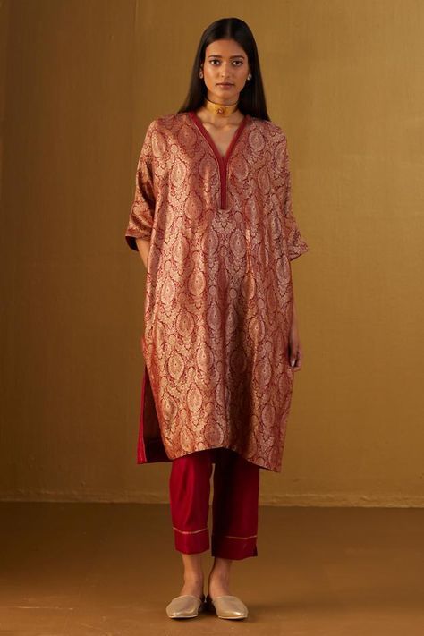 Red kaftan in Mughal brocade with floral patterns and minimal zardozi embroidery. Comes with red cotton silk pant.
Components: 2
Type Of Work: Floral
Neckline: V Neck
Sleeve Type: Three Quarter
Fabric: Kurta: Brocade and Handloom tissue, Pant: Cotton Silk, Lining: Shantoon
Color: Red
Other Details: 
Lace trims
2 pockets on kaftan and pant
Partially elasticated waistband
Length:
Kaftan: 41 inches
Pant: 36 inches
Model height: 5ft 9inches, wearing size M
Note: Dupatta worn by the model is not for Pakistani Kaftan Suits, Red Brocade Suit, Brocade Kurta Designs, Kaftan Suit Design, Brocade Kurti Design, Banarasi Outfits, Brocade Dress Styles, Brocade Kaftan, Brocade Kurta