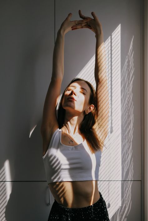 woman in white tank top standing beside white wall photo – Free Barcelona Image on Unsplash