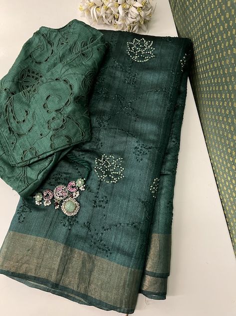 Immerse yourself in sophistication with our deep green handloom tussar saree. This exquisite creation boasts intricate hand embroidery, highlighting enchanting floral motifs with delicate French knots in a subtle shade of light green and glimmering golden zari border. The deep green hue adds an air of mystery to this handloom masterpiece, making it an ideal selection for those desiring elegance with a touch of enigmatic charm. The saree also comes with its own self blouse piece. Pearl Blouse Designs, New Dress Design Indian, Pearl Blouse, Black Dessert, Tussar Saree, Simple Border, Simple Saree Designs, Green French, Latest Dress Design